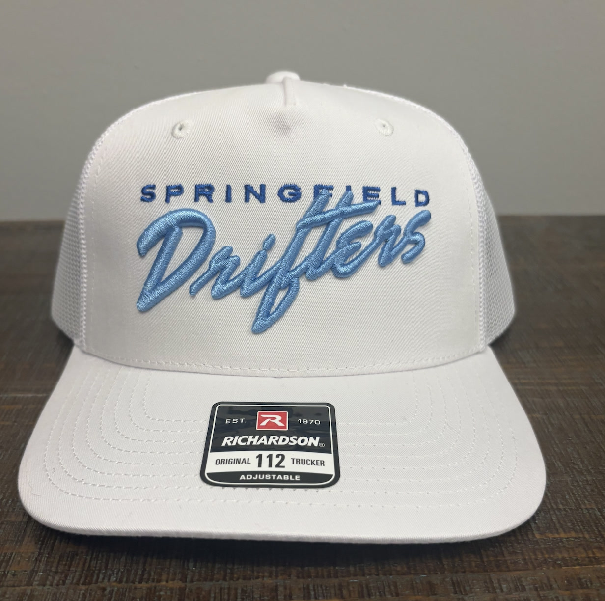 White Richardson 112 trucker hat with Springfield Drifters in raised light blue 3D puff embroidery