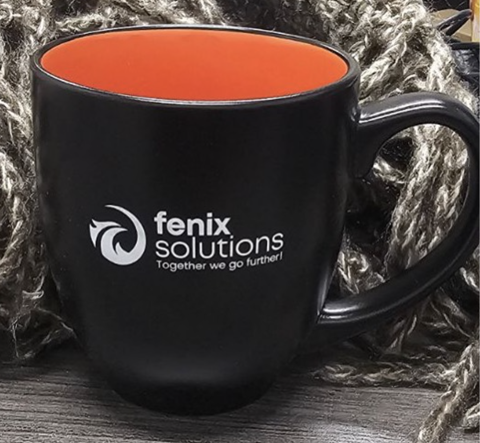 Black coffee mug with orange interior branded with Fenix Solutions logo