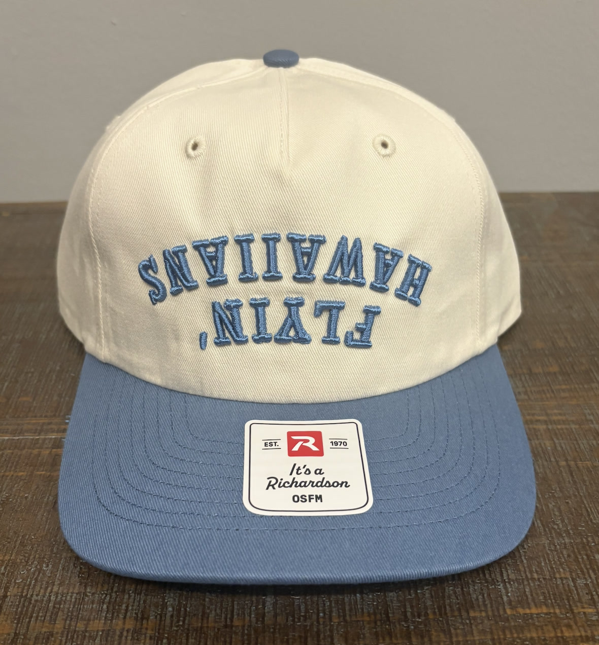 Cream and light blue Richardson cap with raised blue puff embroidery lettering
