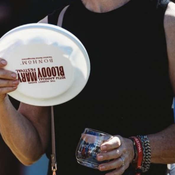 White frisbee and glass with Bloody Mary Festival branding