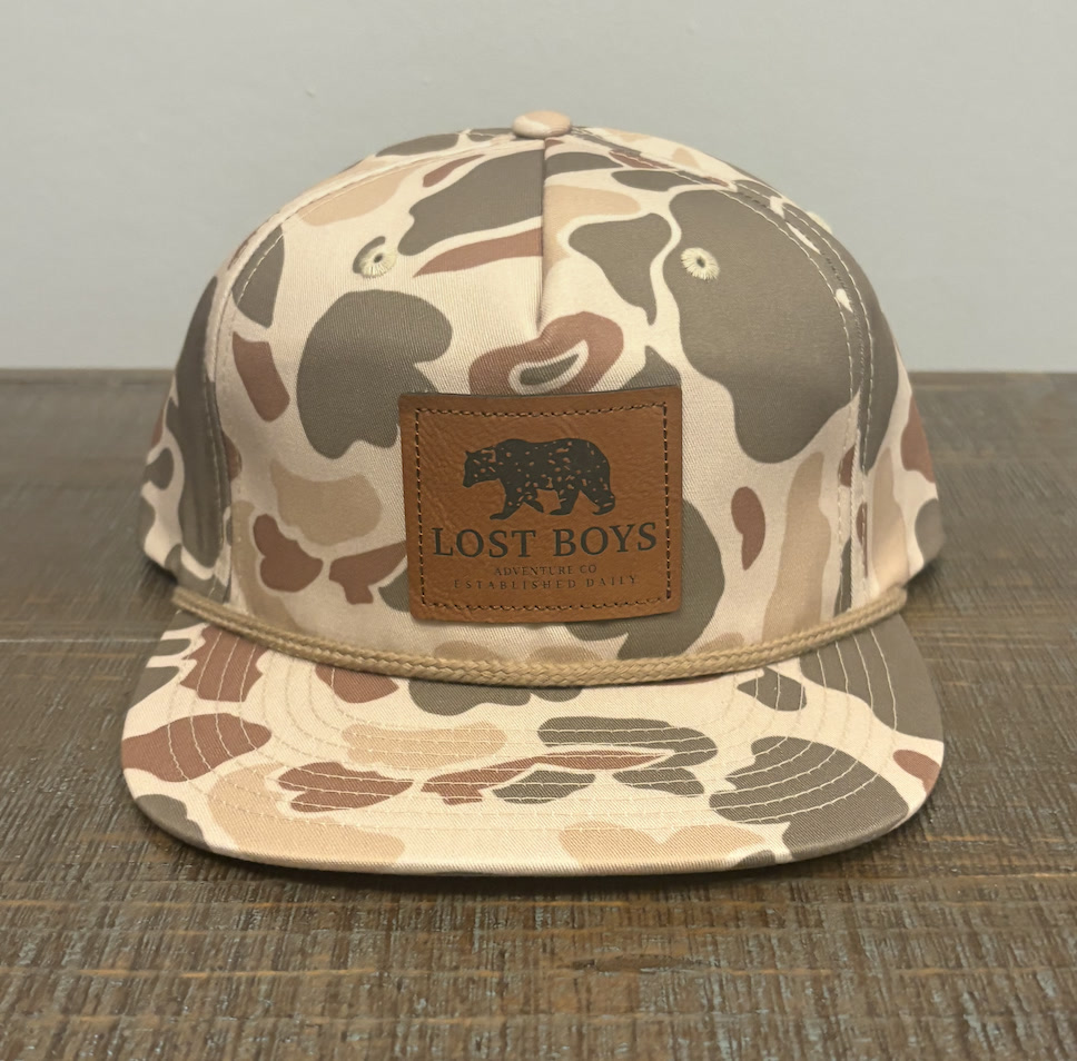 Camo rope hat with a Lost Boys Adventure Co leather patch