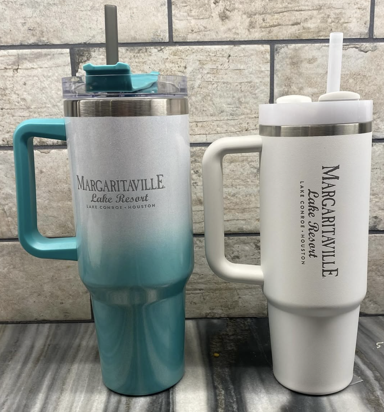 Two Margaritaville Lake Resort branded tumblers in teal and white