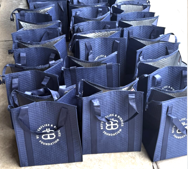 Navy blue insulated tote bags with Butterflies & Birdies Foundation logo