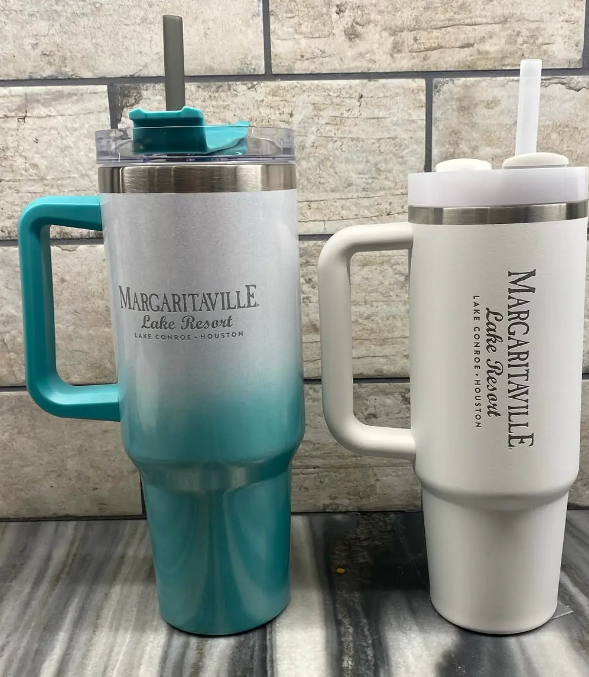 Two laser engraved resort tumblers, one teal ombre and one cream